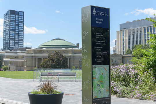 wayfinding sign near the front lawn of St George Campus, University of Toronto, with defocused view of Convocation Hall (31 King's College Cir)