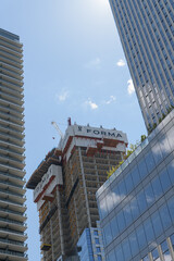 Fototapeta premium sign at the top of a condominium complex under construction at King W and Duncan (Ed Mirvish Way), Toronto
