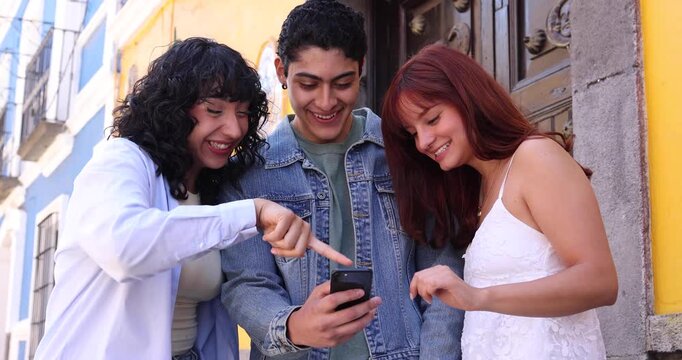 young latin people group of friends using mobile phone in Mexico Latin America
