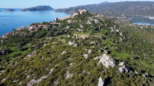 Rising aerial view of Simena castle on Kalekoy hill in Turkey