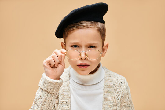 Little boy imagines being a film director with stylish attire and a curious expression