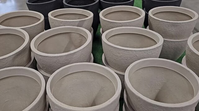 Rows of empty ceramic flower pots displayed for sale in a garden center and home store