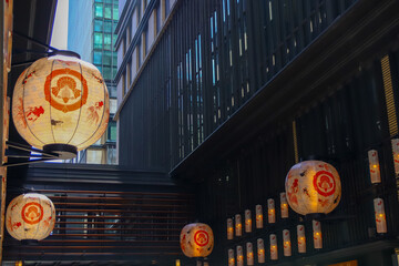 Paper lanterns hanging along a narrow alley at dusk © kodai