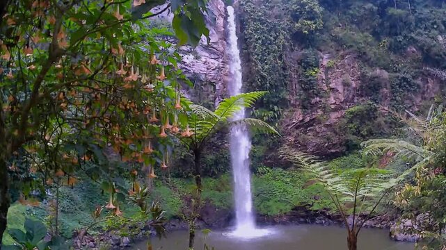 Tropical waterfall cascading into a natural pool surrounded by angel trumpet flowers and lush tree ferns