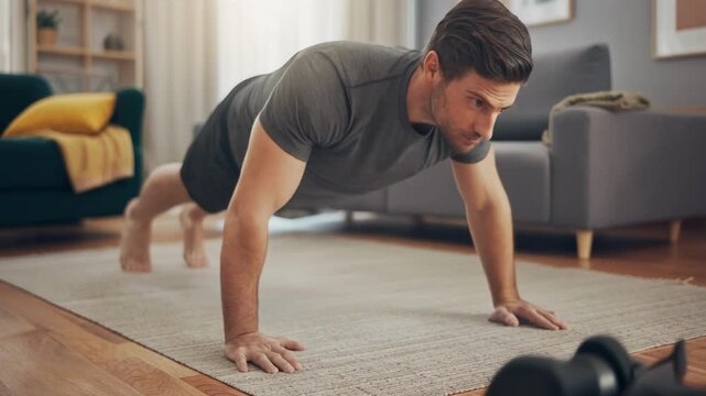 Focused man doing push ups on rug in cozy living room showcasing fitness dedication and healthy lifestyle