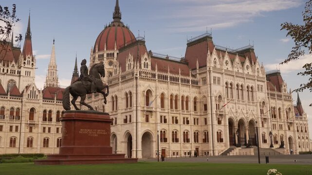Sunlit Parliament and statue Budapest Hungary sunny summer day