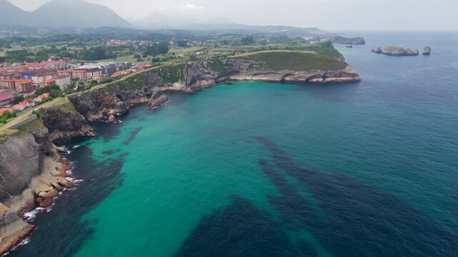 Aerial View of the Sea Cliffs and Green Grass Footpath Along Paseo de San Pedro Hiking Trail in Llanes, Asturias, Northern Spain