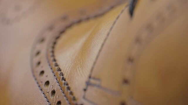 Close look at crafting leather shoes with detail in stitching and design