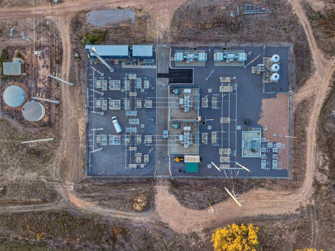 Aerial view of an electrical substation with transformers, switchgear, and power lines situated in the dry landscape near Cape River in Charters Towers Regional, Queensland, Australia.