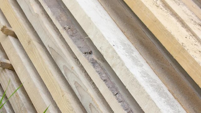 Dry pine boards lumber. Logs processed into sawn boards for construction, building projects, and repairs. Dry boards stacked in piles,animation