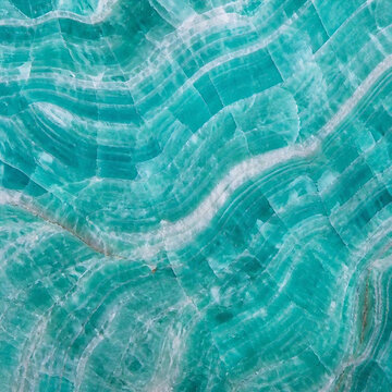 Polished amazonite gemstone surface showing abstract aqua green mineral waves
