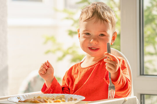 Adorable boy enjoying a nutritious homemade meal by the window.