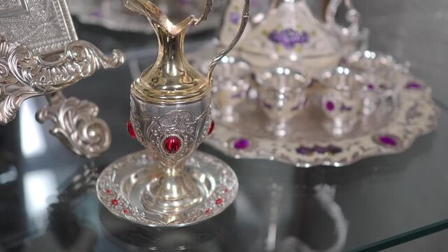 Beautiful silver tea set display in a glass cabinet