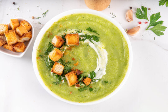 Tasty vegan zucchini cream soup with hard cream and croutons. Homemade green vegetable cream soup puree, healthy low calorie food