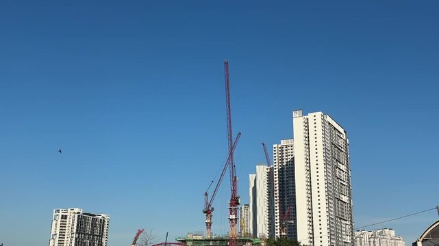 Close up of a massive industrial crawler crane operating at a bridge construction project.
