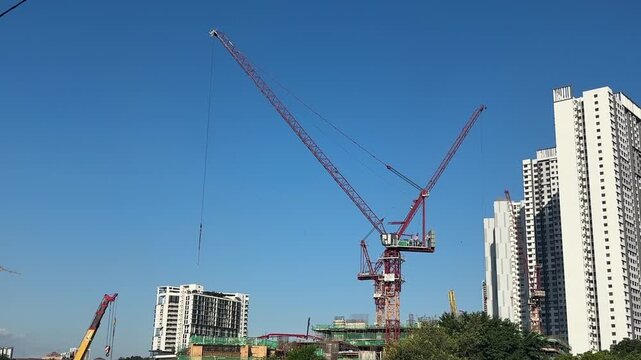 Close up of a massive industrial crawler crane operating at a bridge construction project.