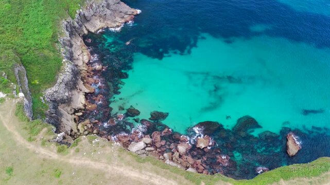 Aerial View of the Sea Cliffs and Green Grass Footpath Along Paseo de San Pedro Hiking Trail in Llanes, Asturias, Northern Spain