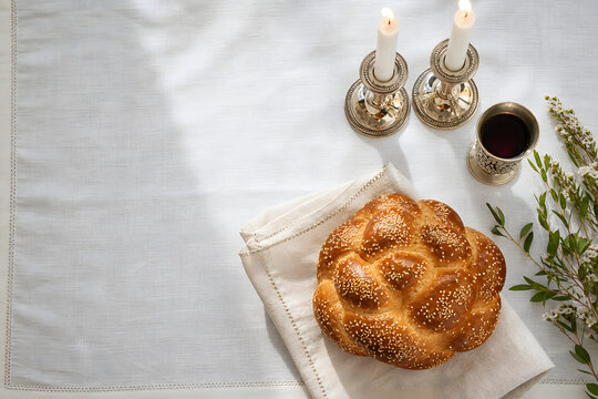 Warm holiday table with challah candles and wine