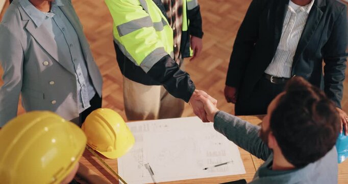Above, blueprint and people shaking hands for construction, phase approval or inspection pass. Floor plan, foreman or building inspector with handshake for compliance, project clearance or remodeling