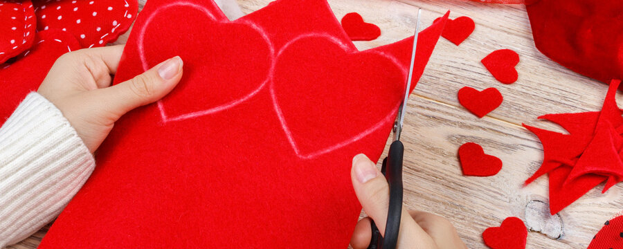Valentines day scrapbook background. Handmade gift greeting heart creating, cut and paste, diy tools on white wood. wedding or other holiday decorations. Above view, flat lay