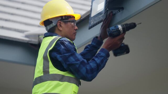 Solar technician wearing safety equipment installs a photovoltaic panel on a residential home, representing renewable energy, skilled labor, clean electricity and sustainable living.