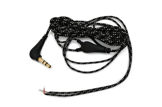 Close-up headphones cable with exposed solder contacts and 3.5mm jack for repair