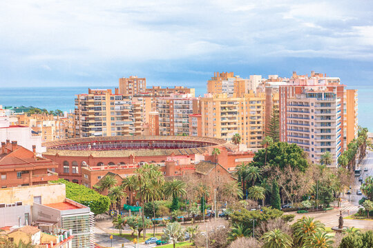 Malaga stunning backdrop for historic Plaza de toros de La Malagueta bullring. High-rise apartment buildings surround the unique multi-sided arena near the sparkling Mediterranean coast in Andalusia