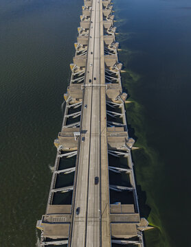 Aerial view of the Haringvlietdam storm surge barrier with a road running across the structure, separating the surrounding water in Haringvlietsluizen, Zuid-Holland, Netherlands.