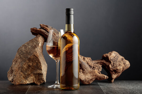 White wine with old snag and a piece of granite rock.