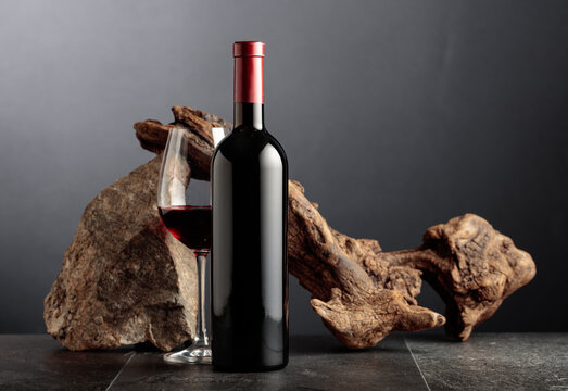 Red wine with old snag and a piece of granite rock.