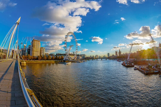 LONDON, ENGLAND - NOVEMBER 28, 2017: View with famous London Eye and Big Ben from Golden Jubilee bridges cross the River Thames. Sunset time.