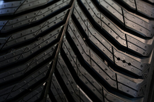 New car tires with a new design is presented at an auto parts fair, expose for selling . Photographed in natural light 