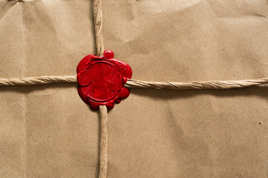 Brown Paper Parcel Wrapped with Vintage Red Wax Seal