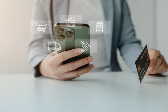 Businesswoman using a smartphone with a credit card to access online shopping services, digital payments, and mobile banking, representing secure ecommerce and modern financial technology.