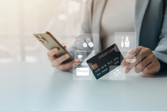 Businesswoman holding a smartphone and credit card while using digital payment technology for secure online shopping, mobile banking and cashless financial transactions in modern business environment.
