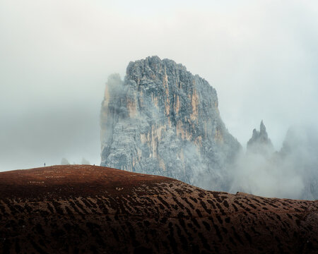Dramatic Alpine Dolomites Peak Rising Through Storm Clouds Foggy at Italy