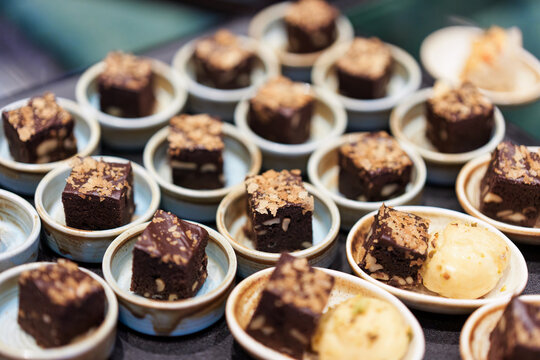 Gourmet Chocolate Brownies Served in Small Ceramic Bowls on Display for Catering Service