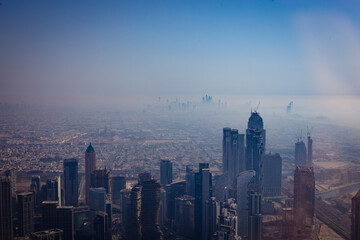 Naklejka premium Urban cityscape skyline of the massive beautiful city of Dubai with its many skyscrapers seen from a high up point of view, Dubai, UAE