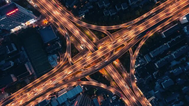  Top‑down aerial drone view of complex multi‑layer highway interchange in modern chinese city, busy urban traffic network 4K