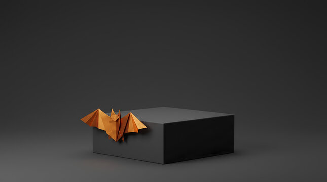 Minimalist matte black box podium decorated with a golden origami bat