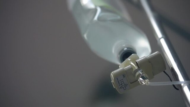 Detailed view of an IV infusion setup used for hospital care, highlighting intravenous fluid delivery, clinical treatment, patient hydration and essential medical equipment.