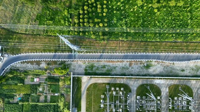 Aerial View of Road and Power Lines Surrounded by Green Landscape