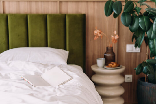 Open book on bed in a modern bedroom during the weekend morning