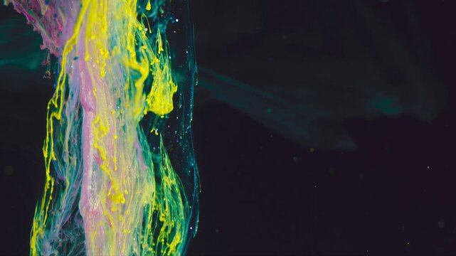 Close-up colorful paint plume descending through dark liquid with neon yellow accents and pastel cyan and pink filaments