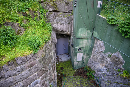 Entrance to a deep underground nuclear fallout shelter in Stockholm Sweden. Heavy blast doors of a subterranean atomic shelter in Stockholm. Deep underground civil defense bunker. Bomb shelter.
