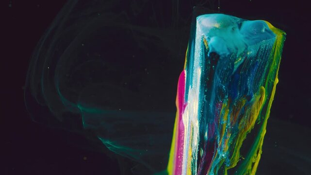 Wet paint column with gravity-driven drips and vivid cyan teal magenta yellow bands against dark background