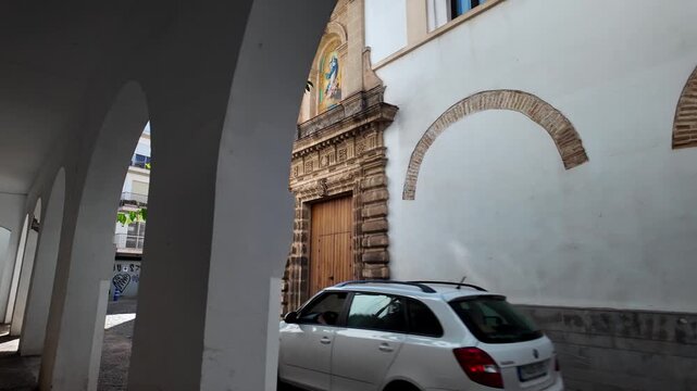 Church view through stone porticos in Jerez de la Frontera, Andalusia