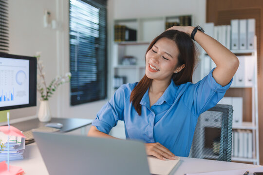 Employee stretching neck during break at office desk