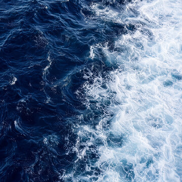 Aerial view of ocean waves with frothy white foam patterns