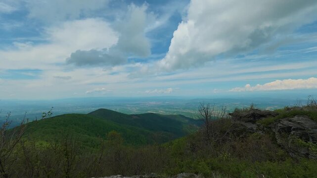 Clouds drift above rolling green hills. Jastrebac Mountain, Serbia. Timelapse